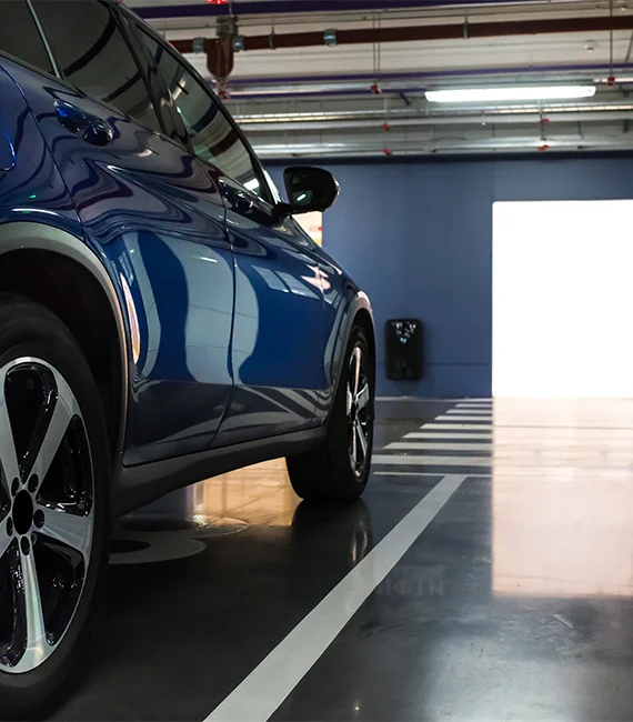 SUV in parking garage, parking garage flooring featured.